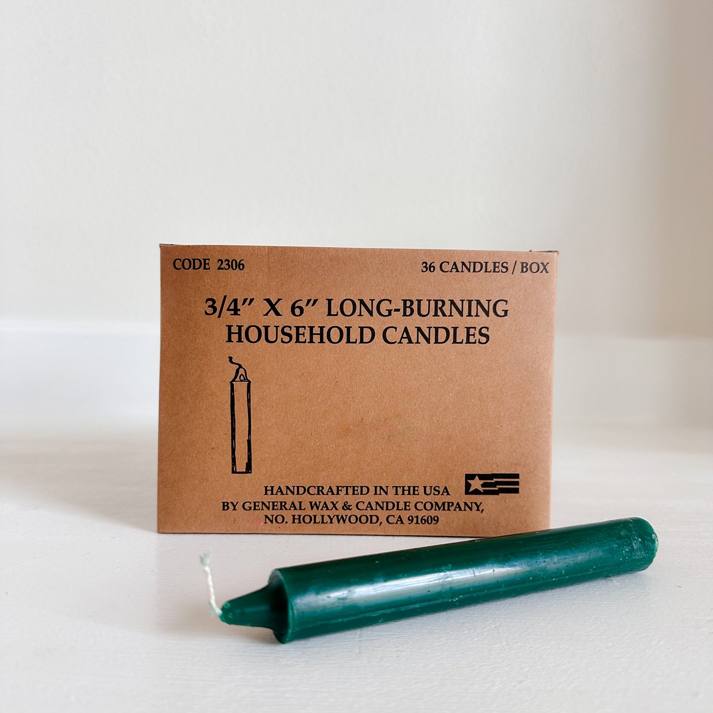 cylindrical household candles green with a box