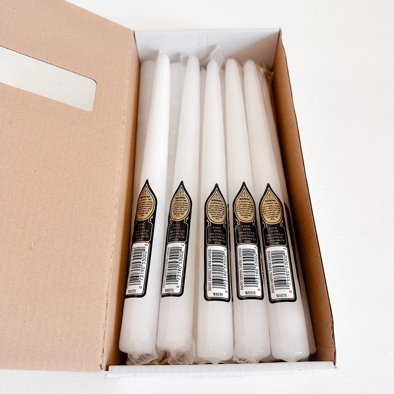 Box of white taper candles
