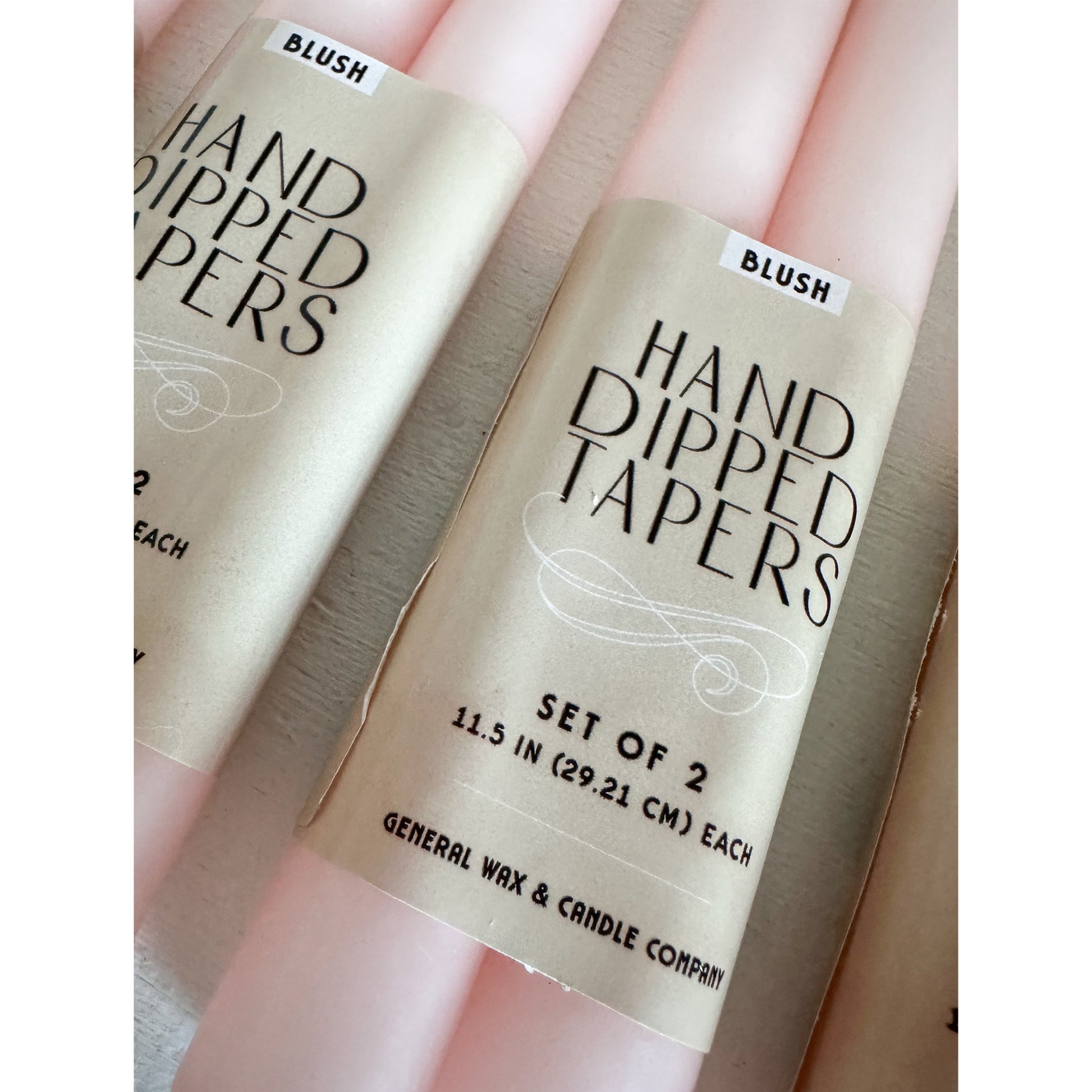 Elegant blush taper candles with connected wick design