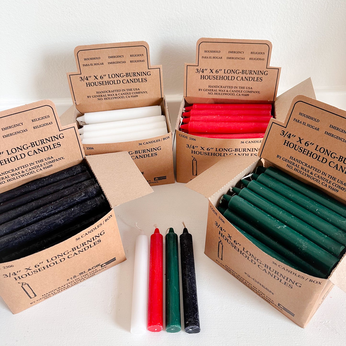 Assorted household utility candles in boxes