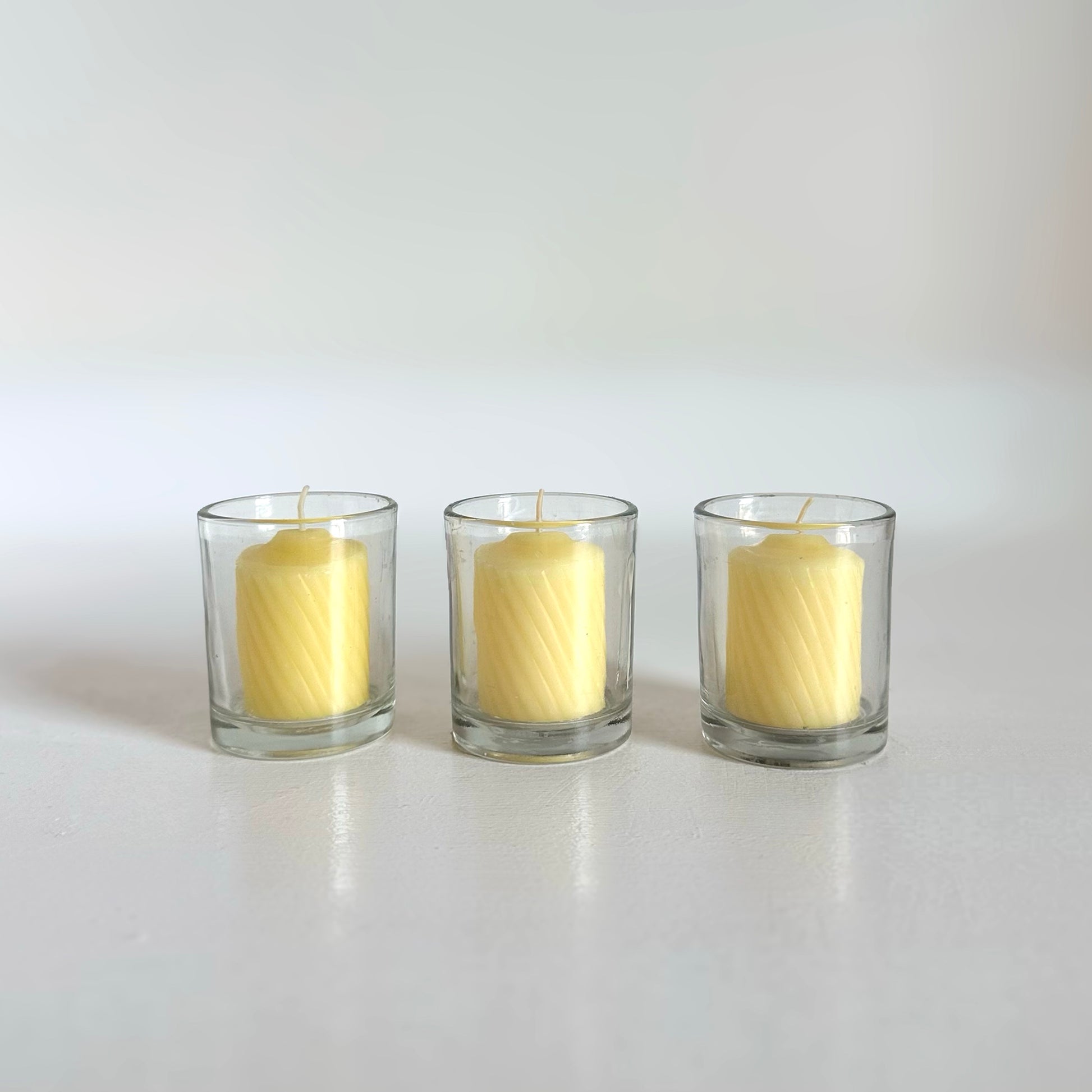 slow burning yellow votive candle