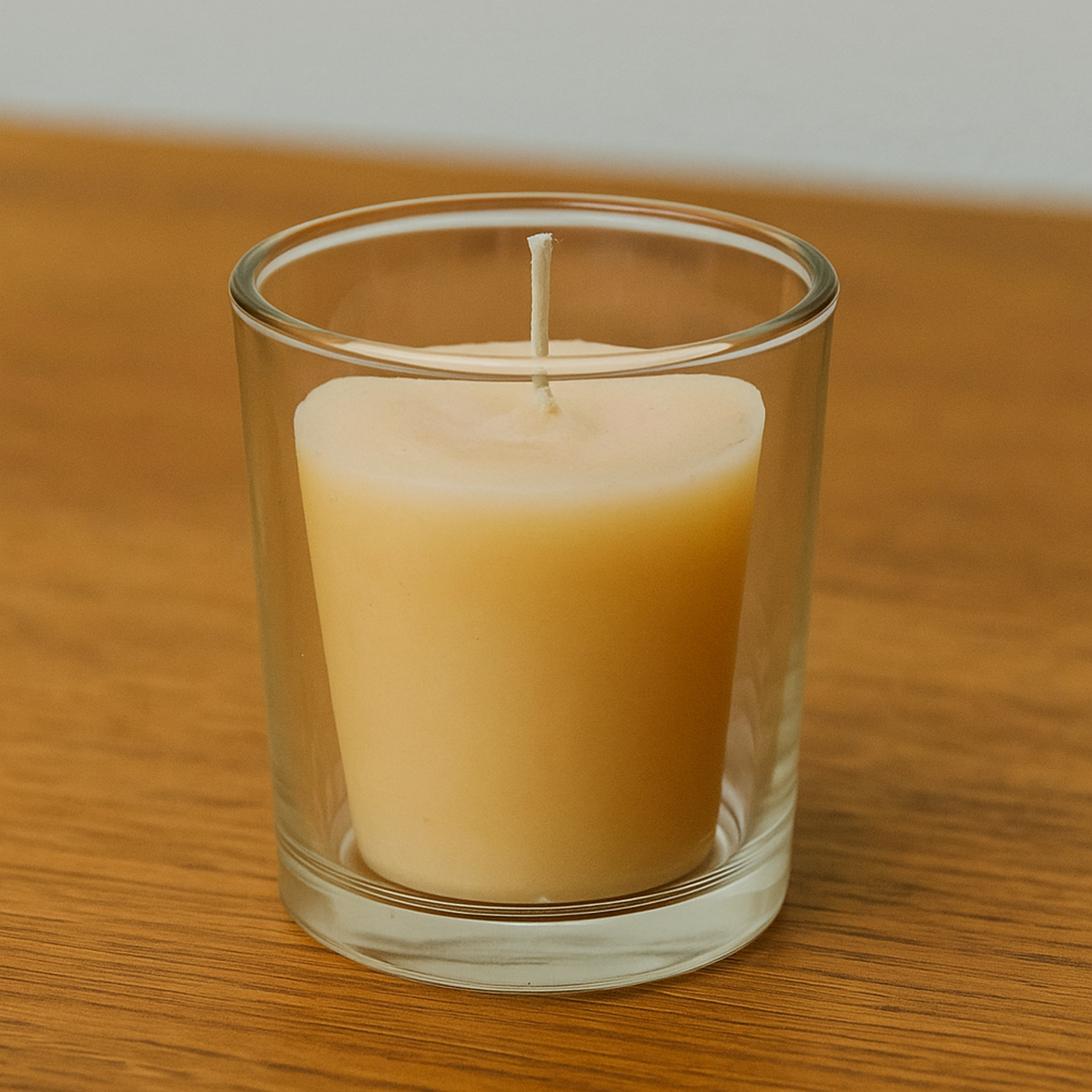 beeswax votive candle in clear glass holder