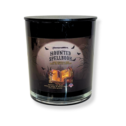 Haunted Spellbook oud scented candle in a dark glass jar with moonlit spellbook artwork and a matte black wooden lid