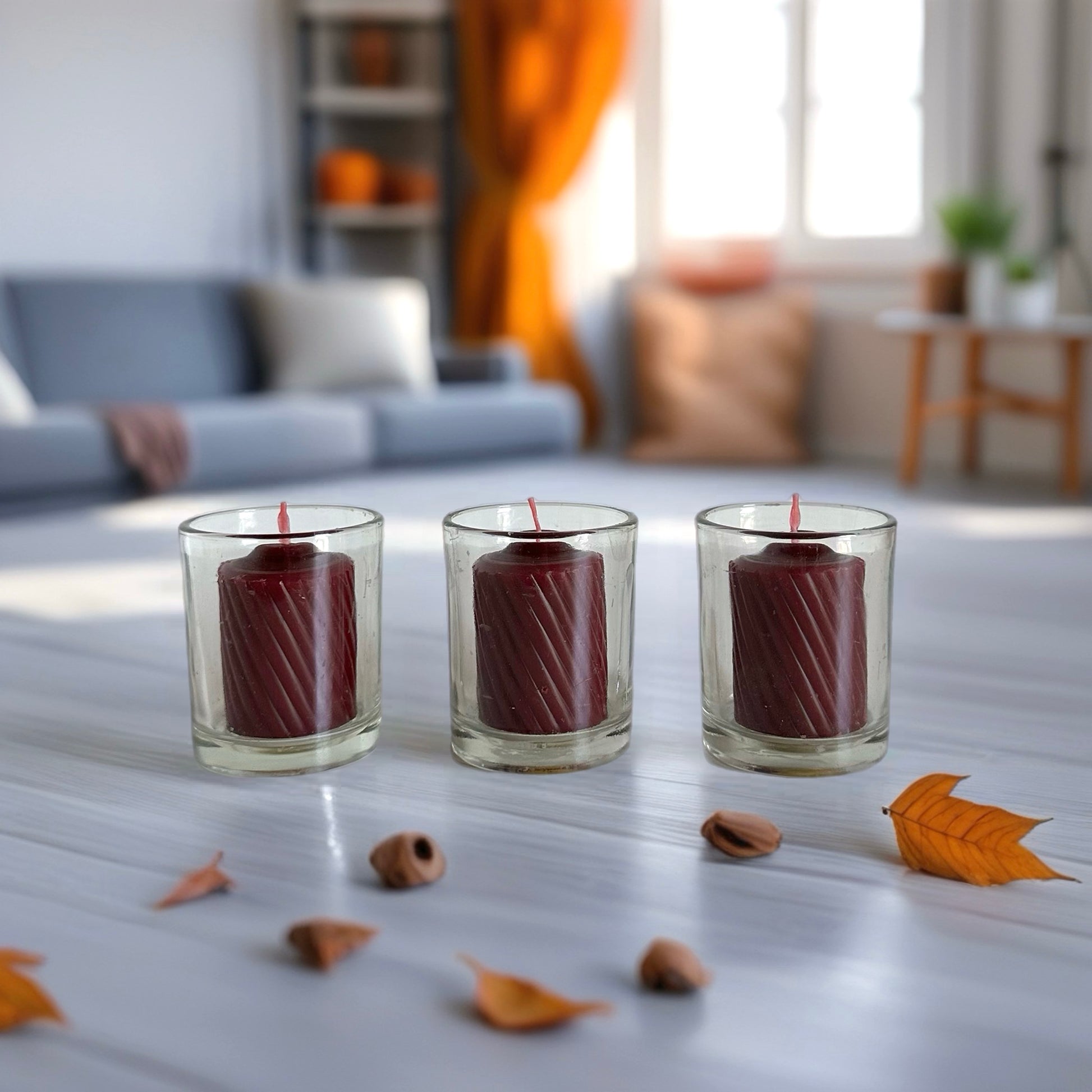 Three red candles in glass holders 